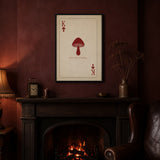 King of Spores print framed in black above a mantelpiece with a fire burning low, shown in 50x70cm