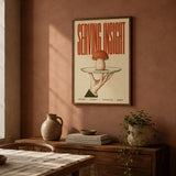Serving Insight print framed in walnut on a terracotta wall above a sideboard, shown in 50x70cm